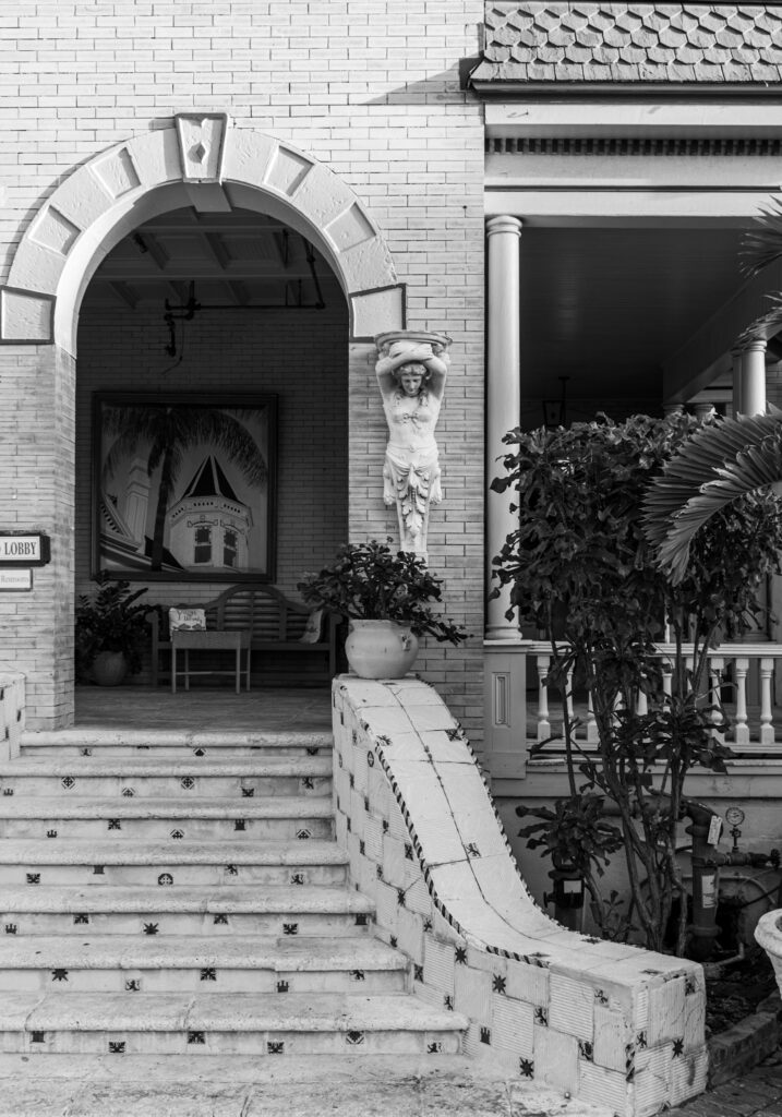 Historic hotel entrance with an arched doorway and staircase, illustrating access information guests need before booking.