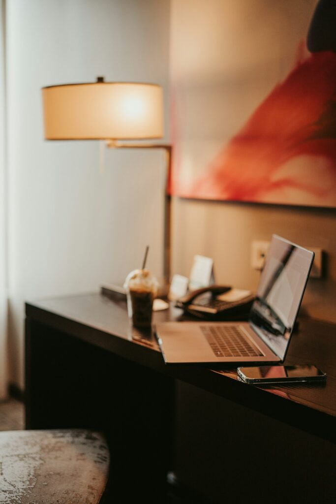 Laptop on a desk in a hotel room, illustrating online hotel booking information and form usability.